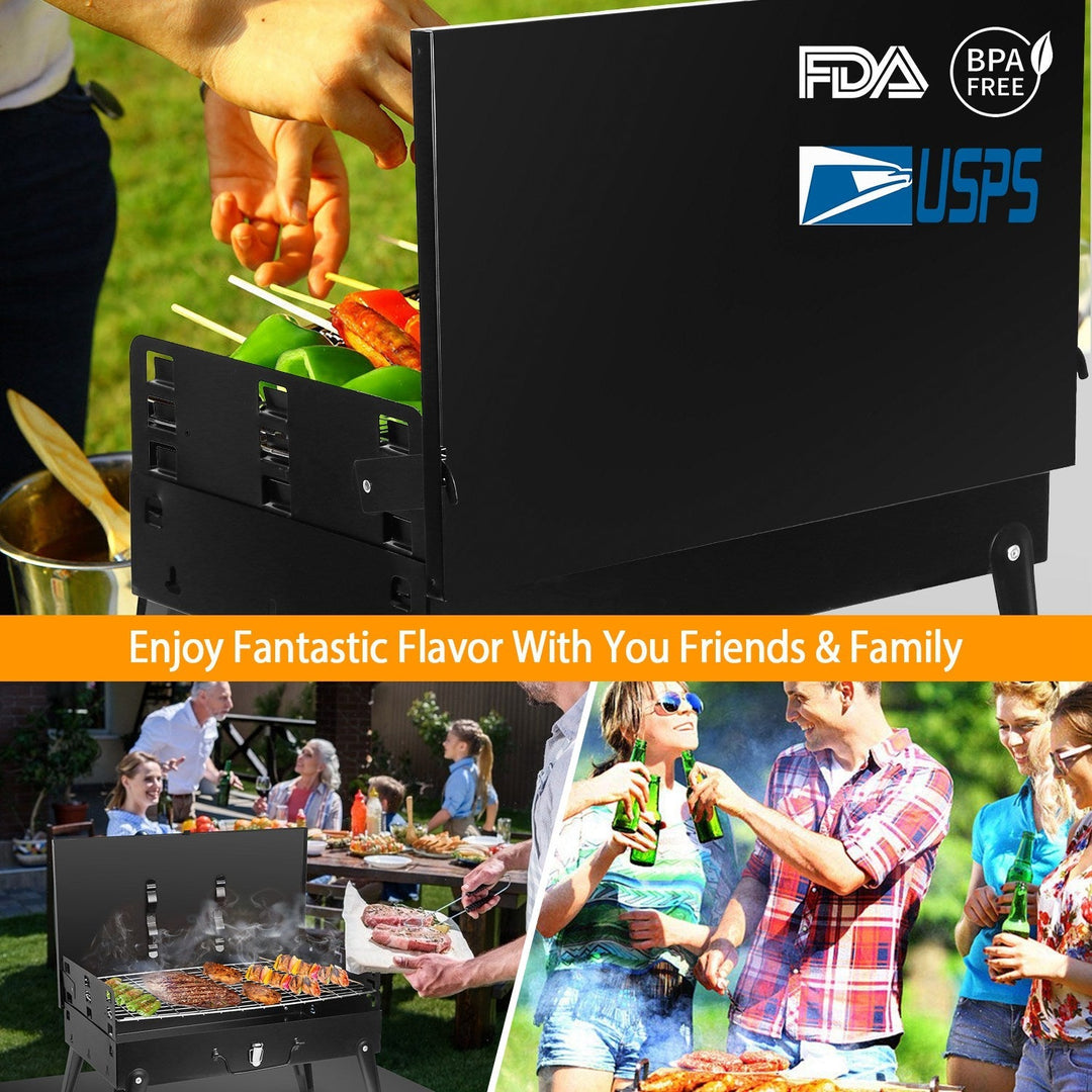 Black charcoal grill with side shelf and skewers, set up for outdoor grilling