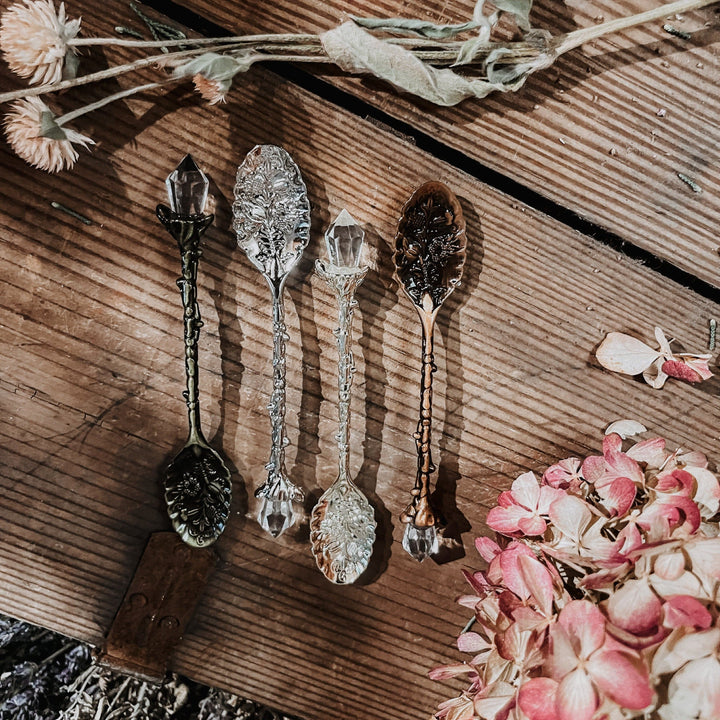 Set of crystal stirring spoons with faceted bowls and decorative metal handles