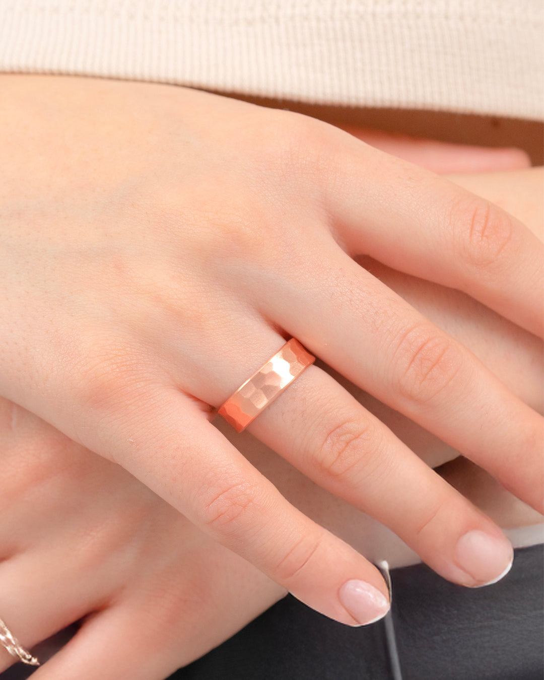 Hammered copper band ring, 6mm, detailed close-up on finger
