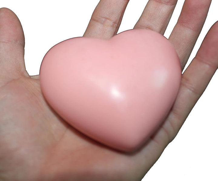 Pink wax heart freshener held in a hand