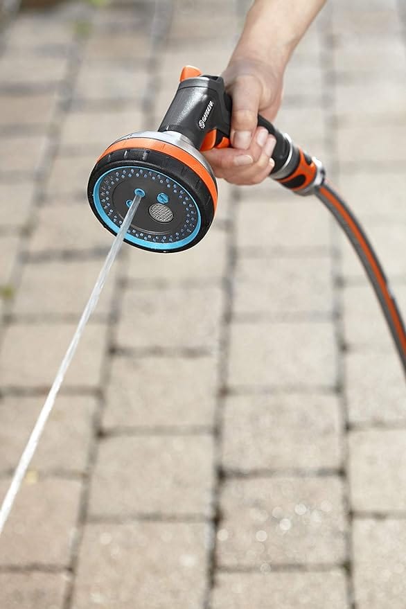 Handheld garden hose sprayer delivering a steady water stream from blue ring nozzle