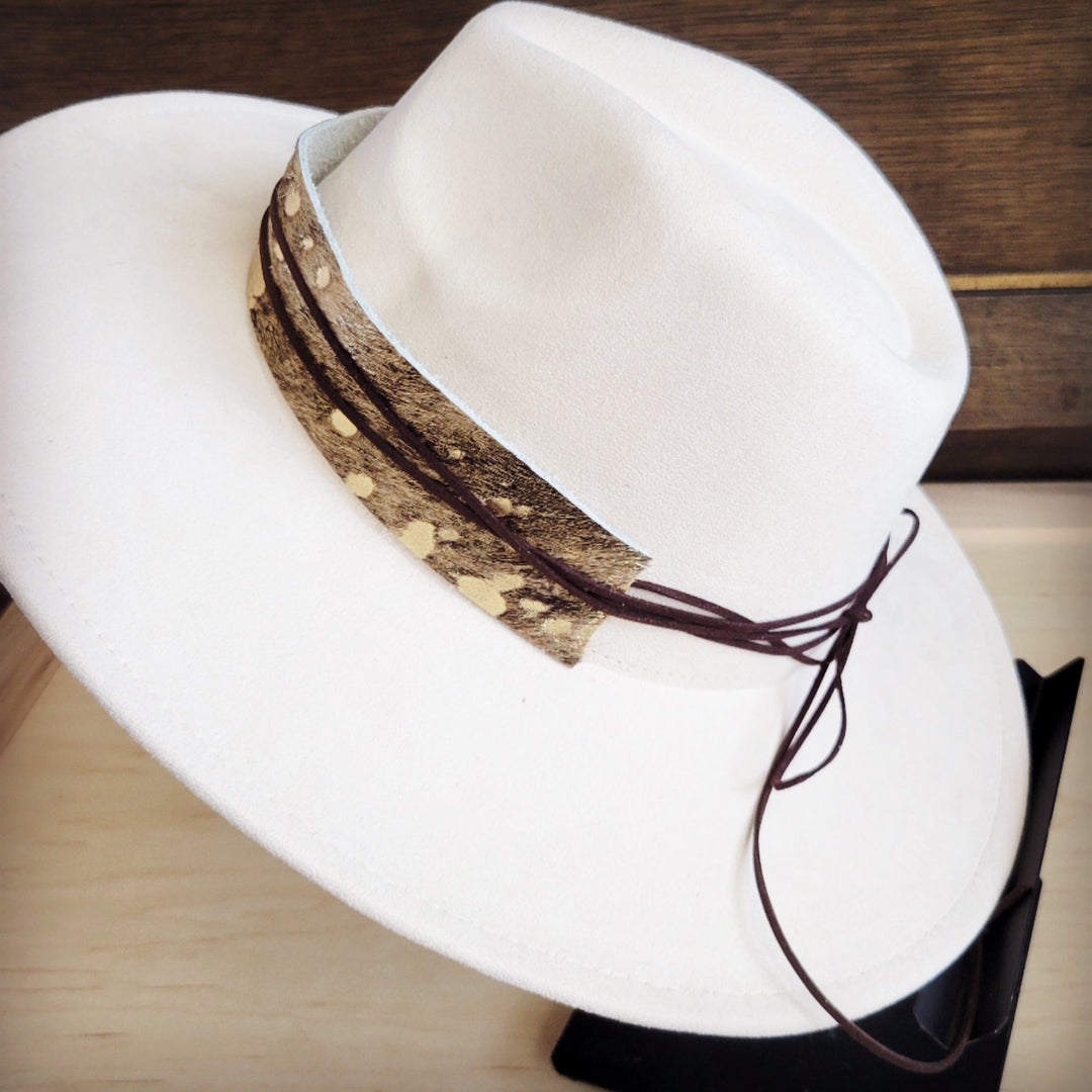 White wide-brim felt hat with brown metallic hair-hide band and tied cord ends