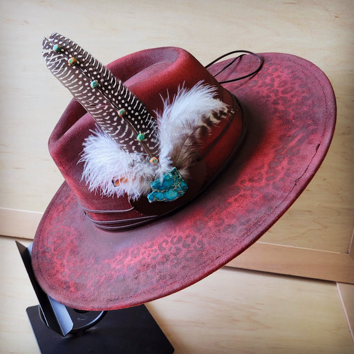 Feather hat band with turquoise stone accents, white feather and black braided strap