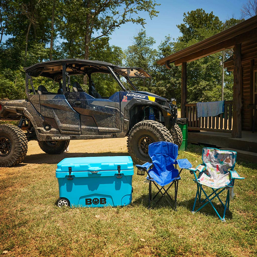 Cool Blue hard cooler on wheels with BOB logo and black side straps