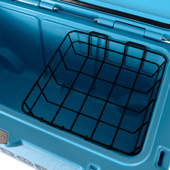 Cool blue hard cooler interior with black wire basket rack on lid side.