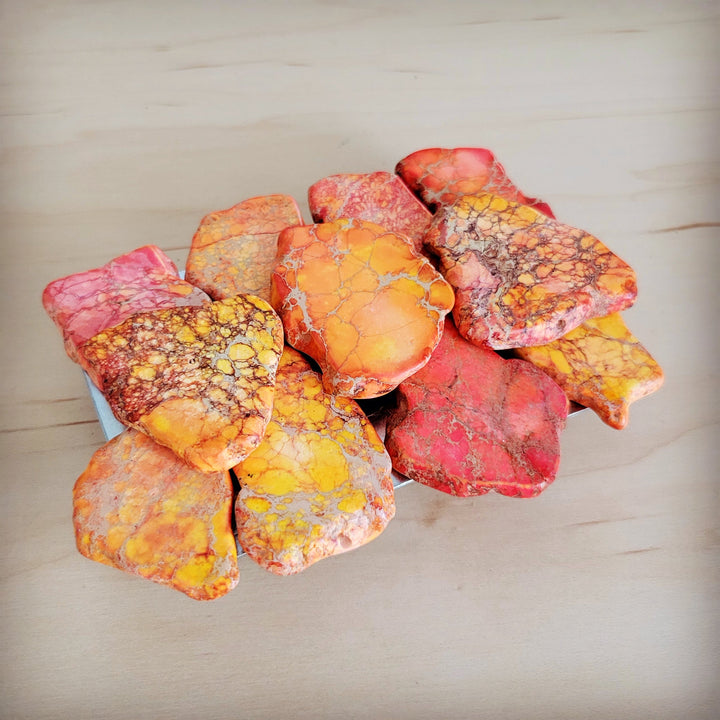 Orange regalite slab belt buckle with multicolor red-yellow stone petal cluster