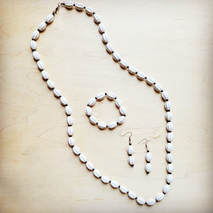 White oval beaded necklace set with matching bracelet and cross drop earrings