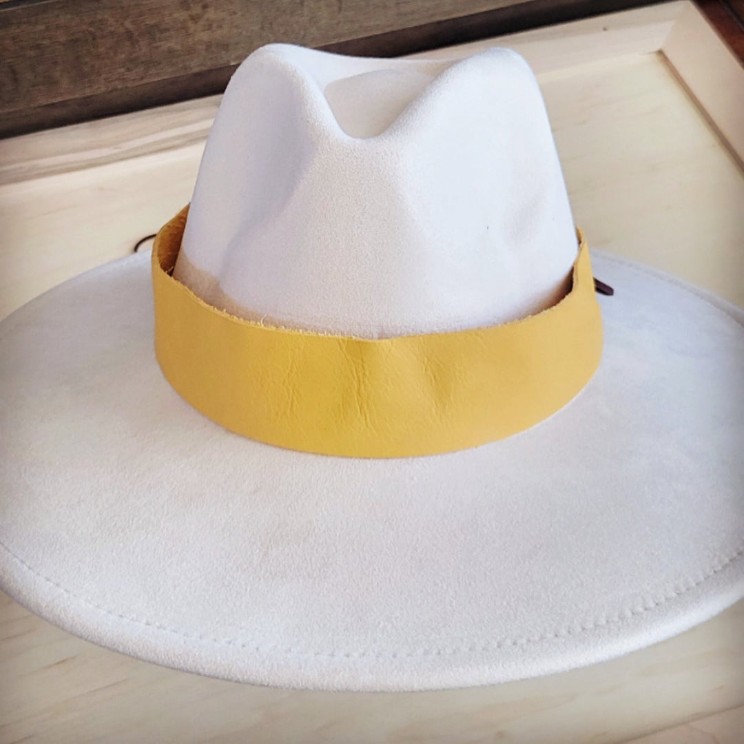 White felt wide-brim hat with mustard leather band centered on crown