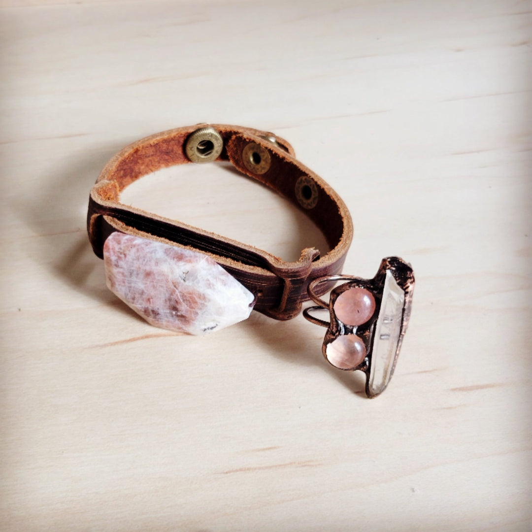 Brown leather cuff bracelet with pink-white crystal, metal hinge clasp, and studs