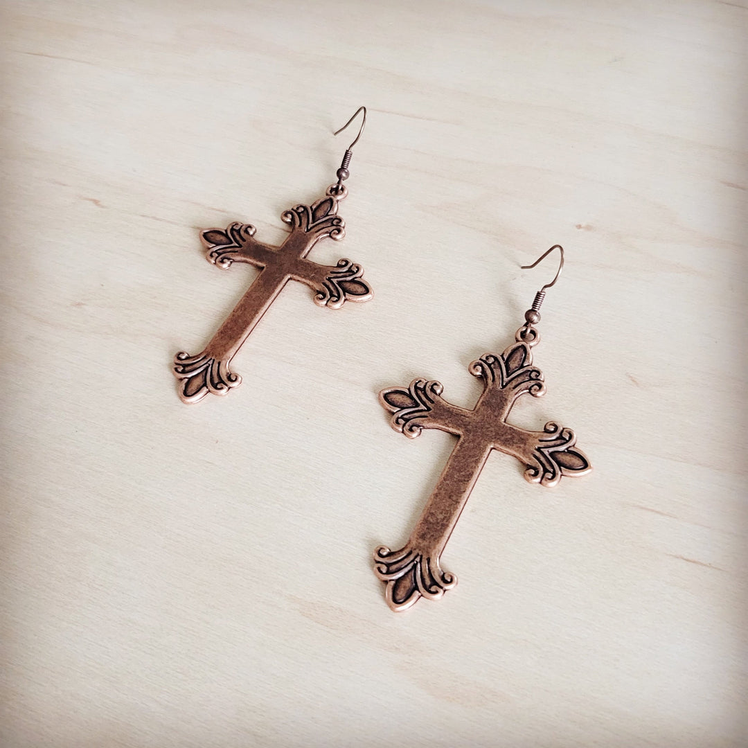 Ornate burnished copper cross earrings with dangling fishhook hooks