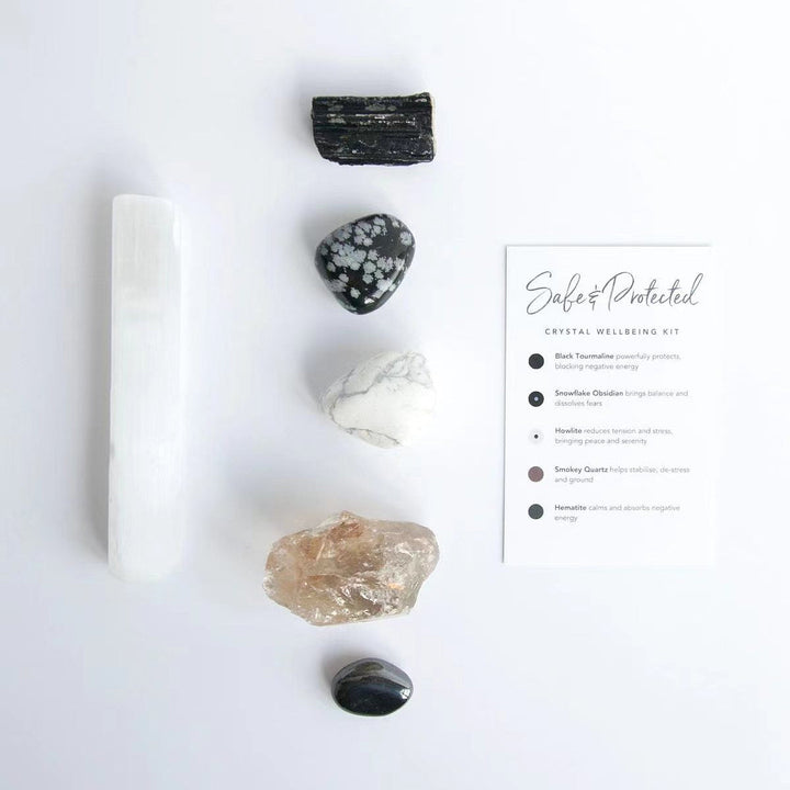 Crystal healing kit with white selenite wand, black and clear stones, plus instructions card.