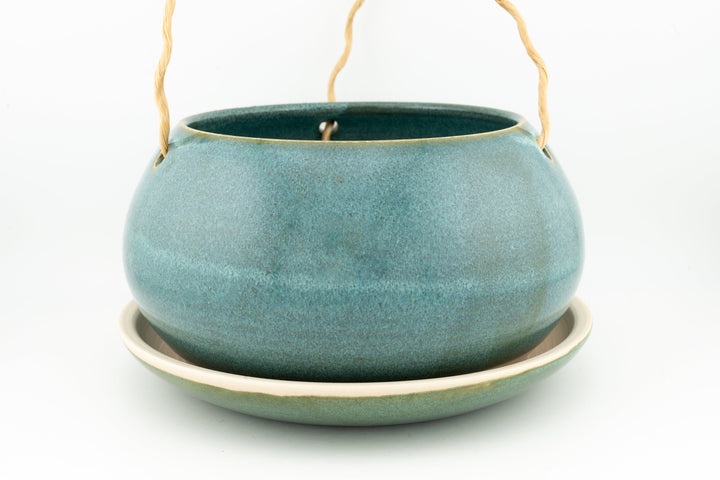 Glazed hanging planter with rope handles and round saucer base, muted teal