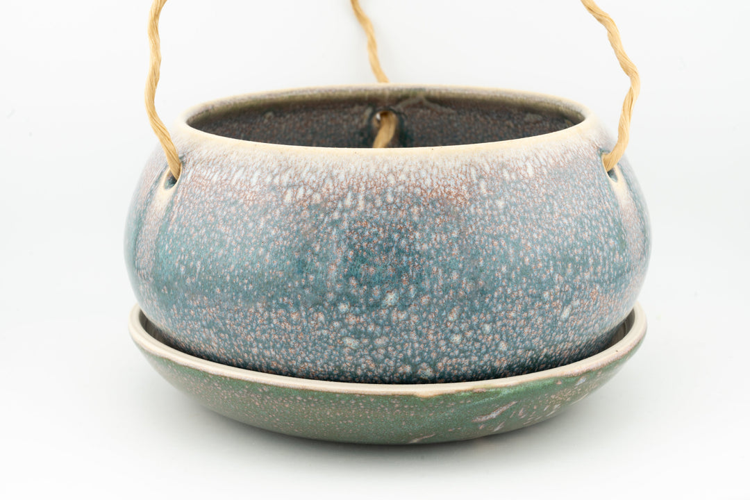 Glazed hanging planter with rope handles and round saucer base, speckled blue-green