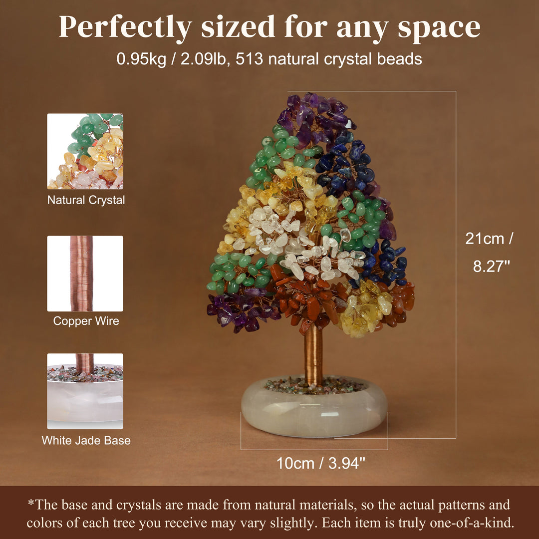 Crystal tree ornament with green, dark blue, and amber crystal clusters on a white jade base