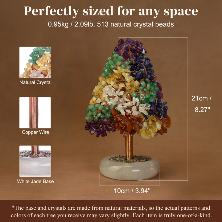 Crystal tree ornament with green, dark blue, and amber crystal clusters on a white jade base