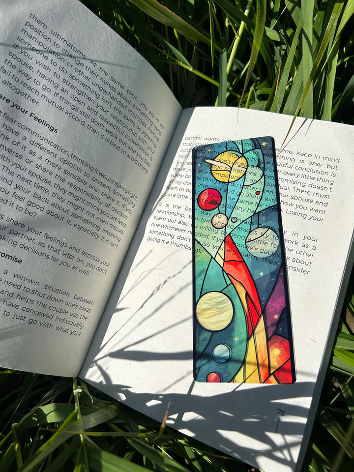 Vintage space-themed bookmark with planets, rocket, and starry gradient artwork.