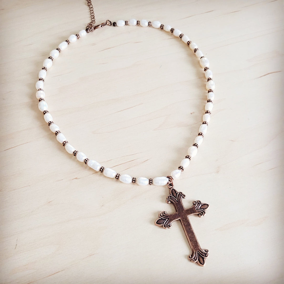 Freshwater pearl bead necklace with copper-toned cross pendant detail