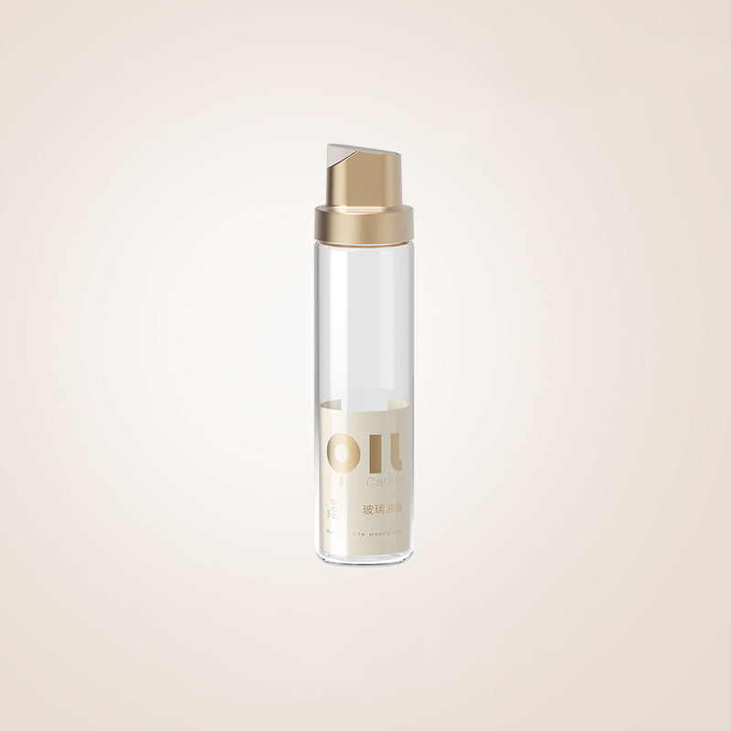 Clear glass oil dispenser bottle with platinum-toned cap
