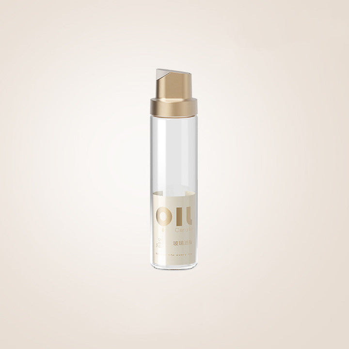 Clear glass oil dispenser bottle with platinum-toned cap