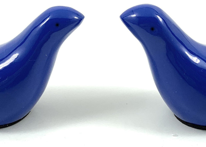 Close-up of two blue bird figurines facing each other