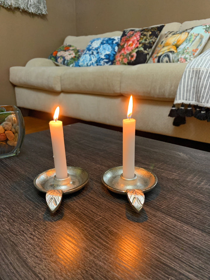 Silver taper candle holders, set of 2, each with a centered socket and leaf base