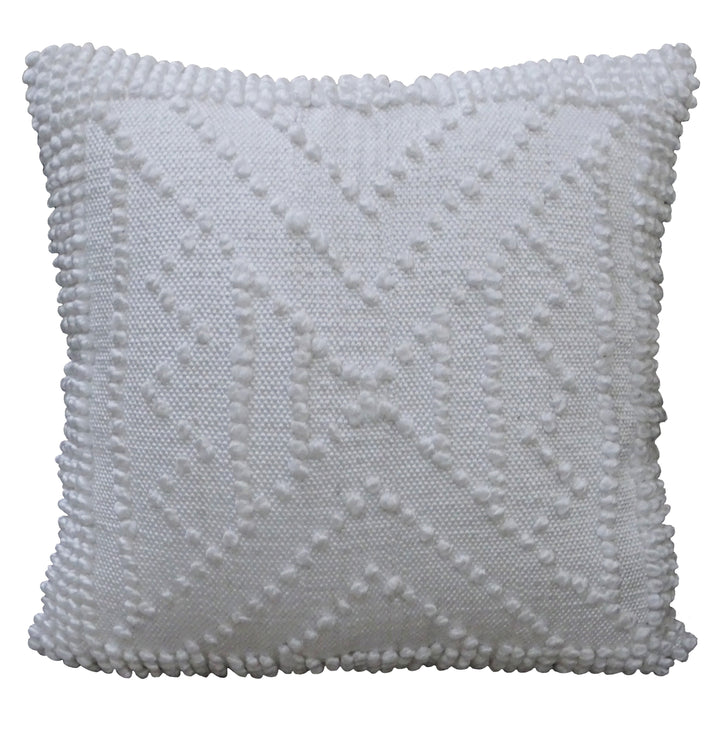 White outdoor decorative pillow with raised geometric texture and pom pom fringe