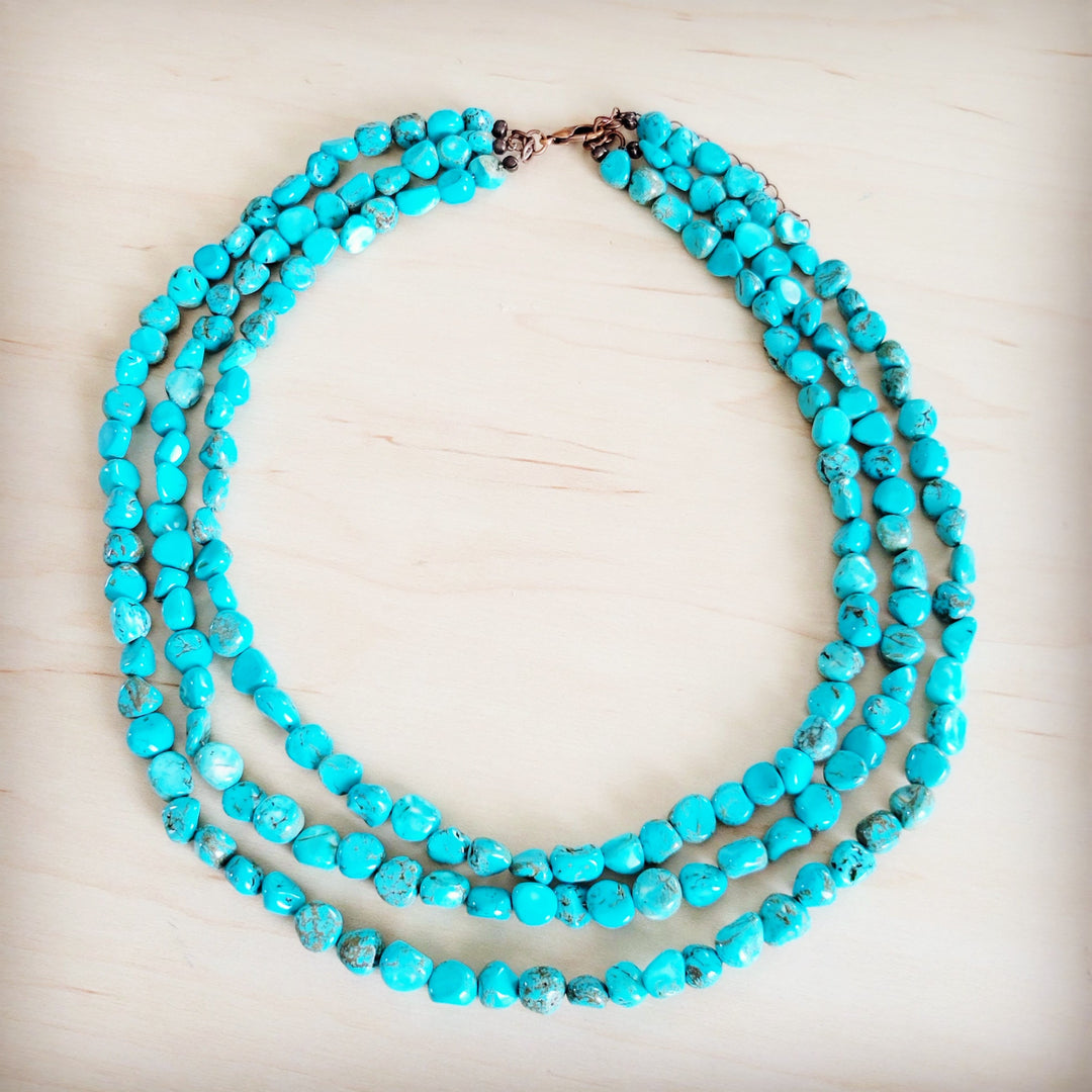 Triple-strand turquoise bead necklace with layered bead strands and metal closure