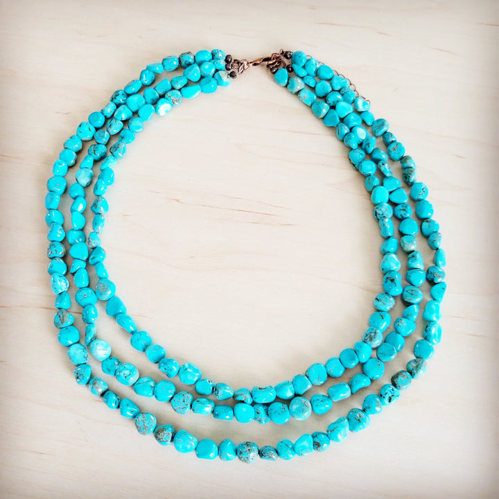Triple-strand turquoise bead necklace with layered bead strands and metal closure