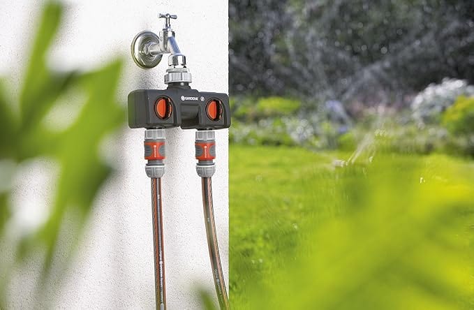 Two-way faucet adapter connected to a garden tap with two hose connections