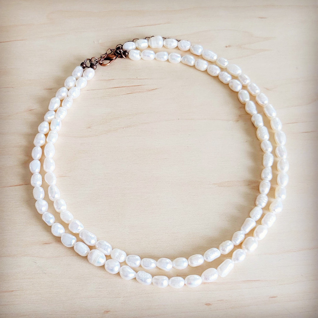 Double-strand freshwater pearl necklace with rose-tone clasp and rounded pearl strands