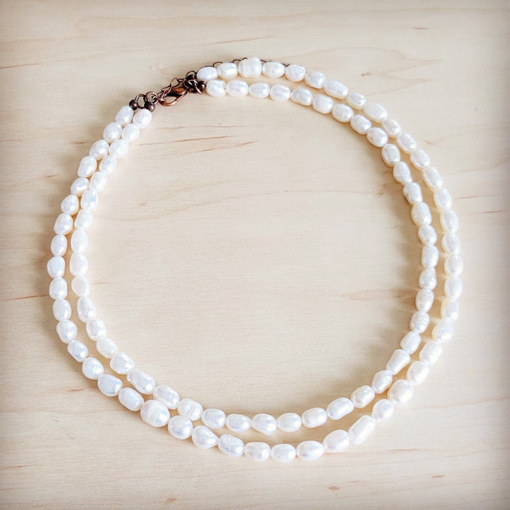 Double-strand freshwater pearl necklace with rose-tone clasp and rounded pearl strands