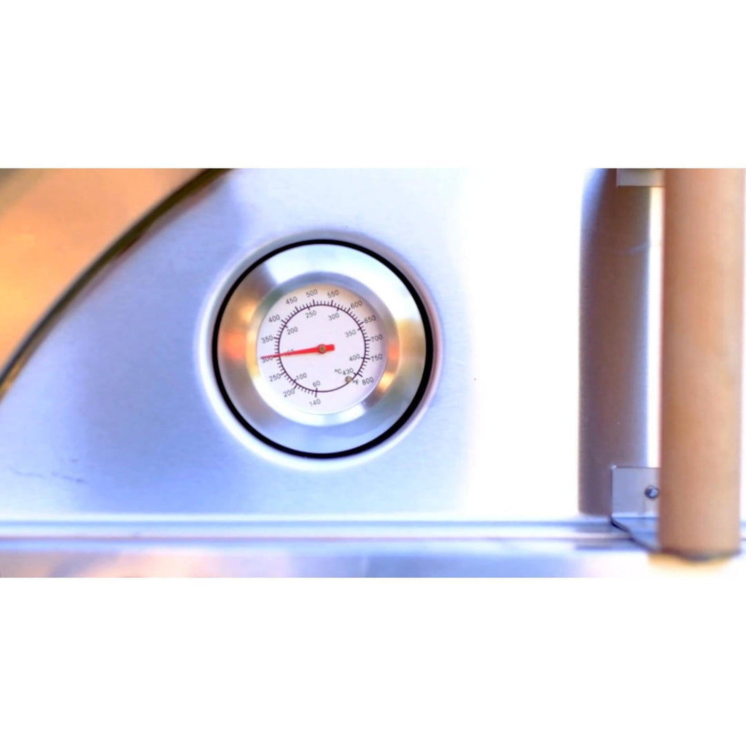 Wood-fired oven interior thermometer gauge on stainless panel