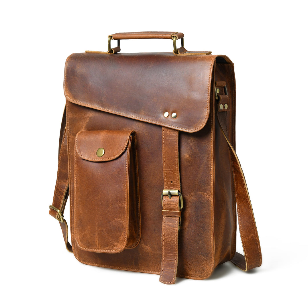 Brown leather crossbody bag with top handle, flap closure, and side belt strap