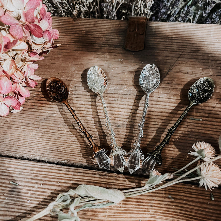 Crystal stirring spoons with faceted bowls and ornate handles, five pieces