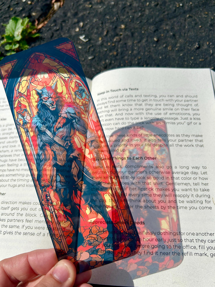 Demon werewolf bookmark, stained-glass artwork in red and blue, held in hand