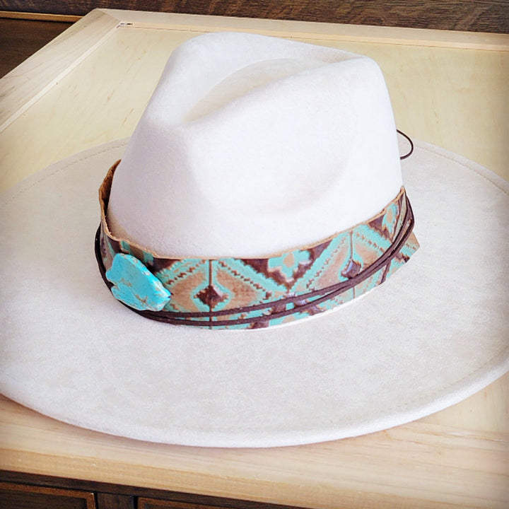 White felt cowboy hat with turquoise leather band and embossed geometric motifs