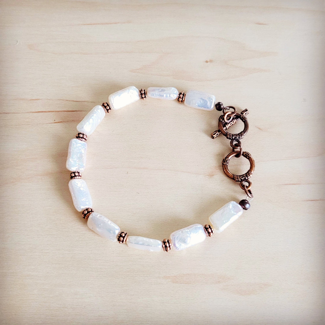 Rectangular freshwater pearl bracelet featuring copper-tone links and secure clasp