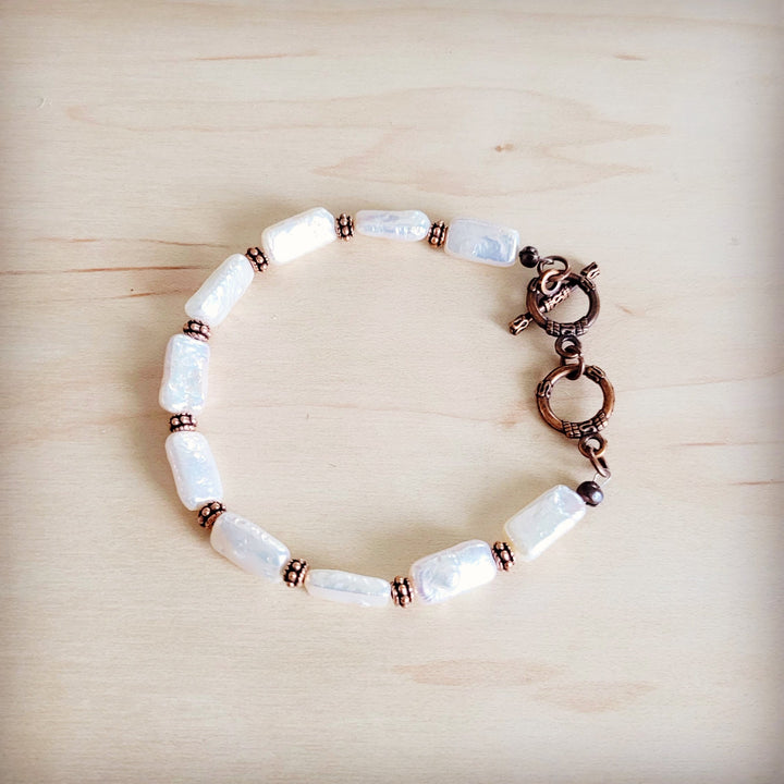 Rectangular freshwater pearl bracelet featuring copper-tone links and secure clasp