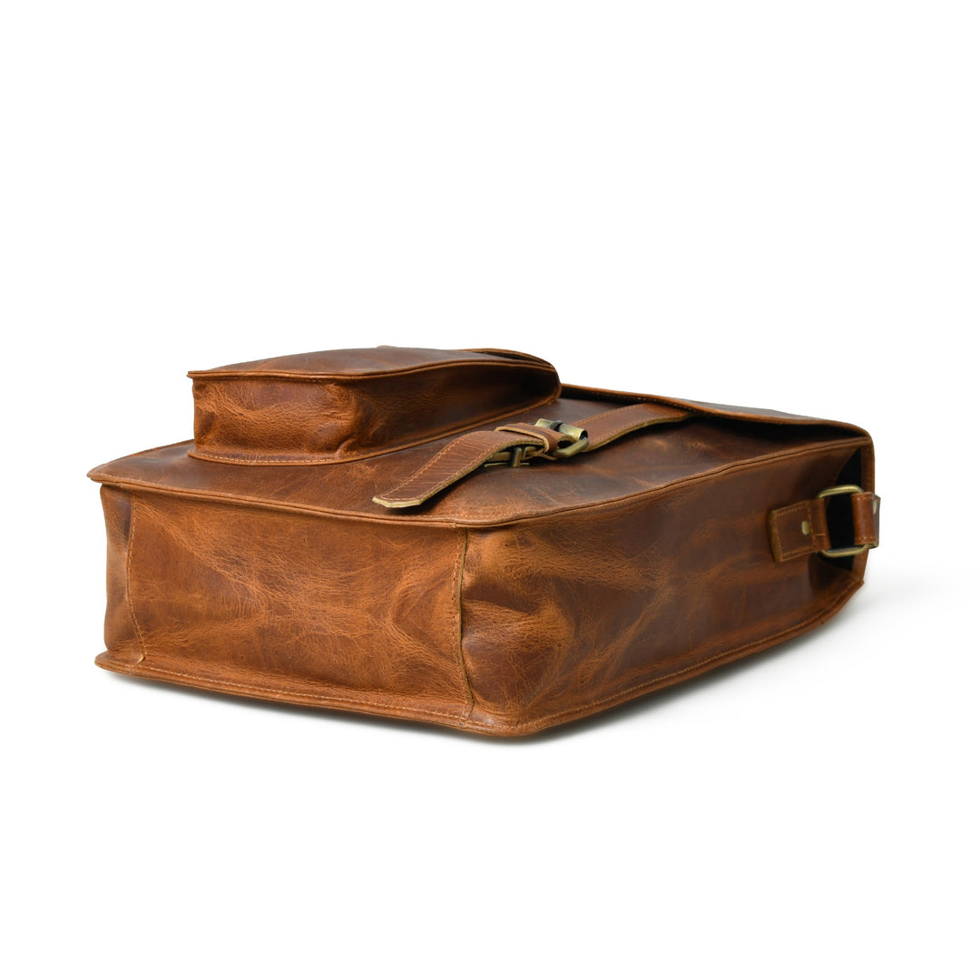 Brown leather crossbody bag side view with magnetic flap and open top pocket