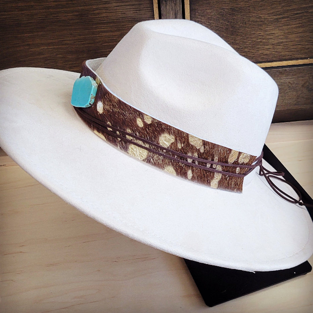 White felt hat with wide cowhide leather band, turquoise ornament, and hanging tie cords