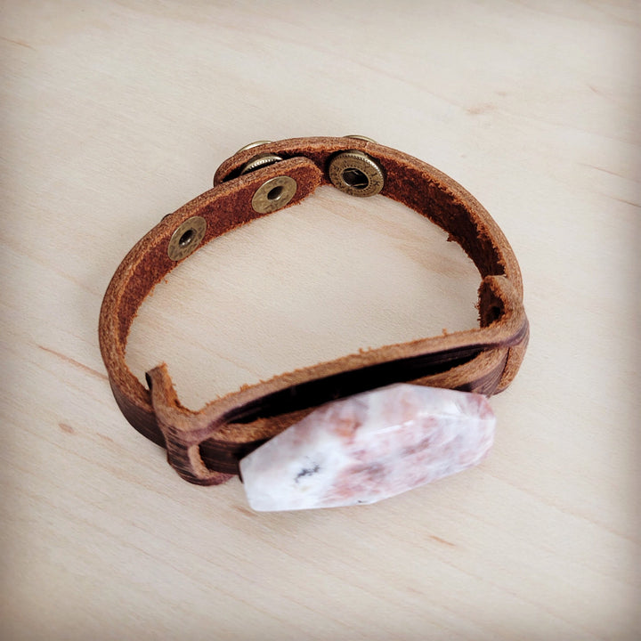 Brown leather cuff bracelet with adjustable strap and pink-white crystal front