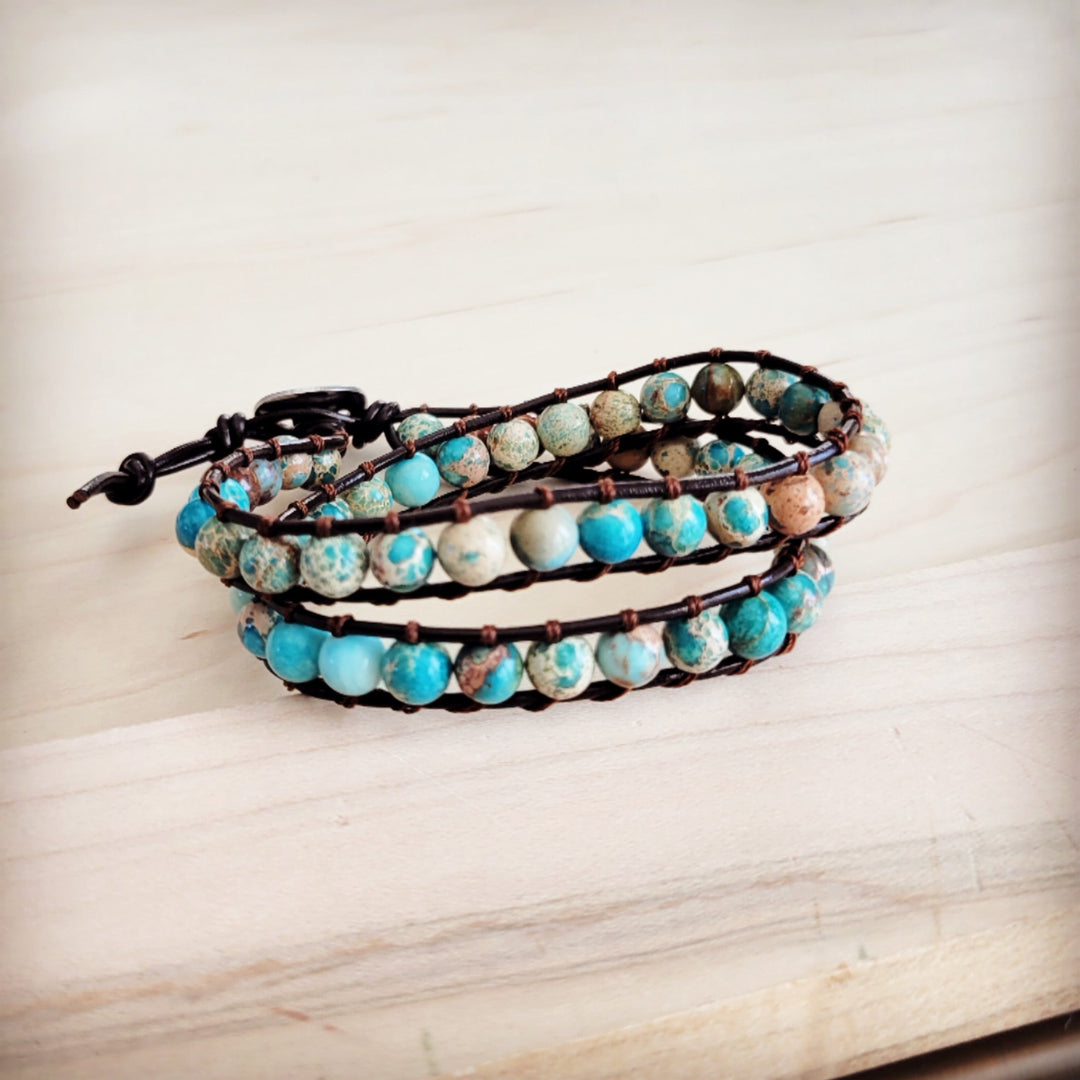 Leather double-wrap bracelet with turquoise, white, and brown beads on dark braided cords