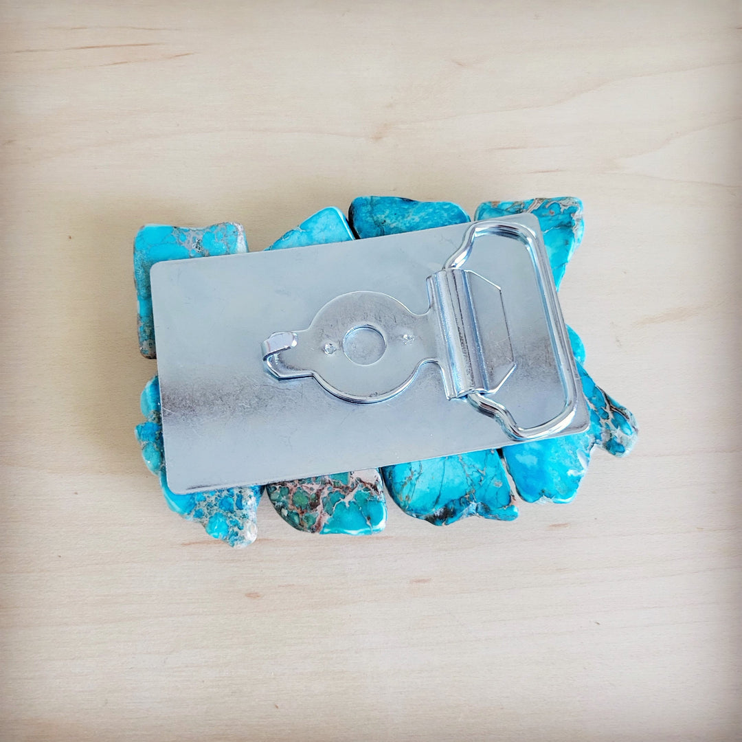 Silver belt buckle setting over turquoise stone slabs with a hinged loop detail