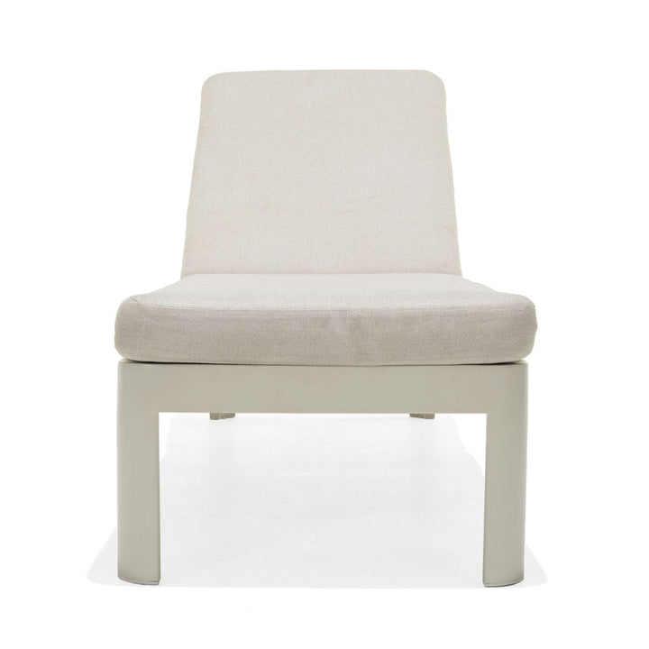 Beige upholstered sun lounger chair with padded seat and back, white frame, four legs