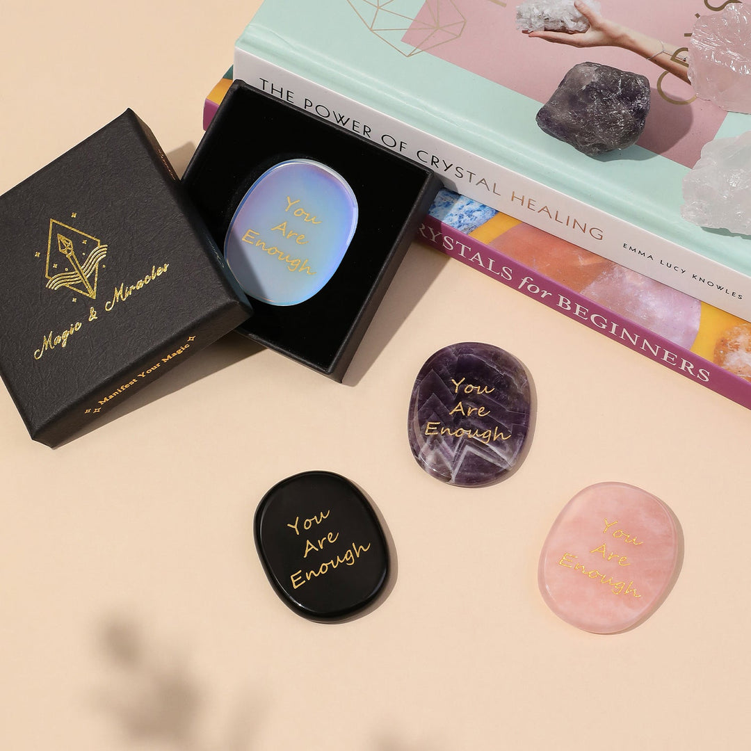 Assorted pocket crystal stones in a box, each with "You Are Enough" engraving
