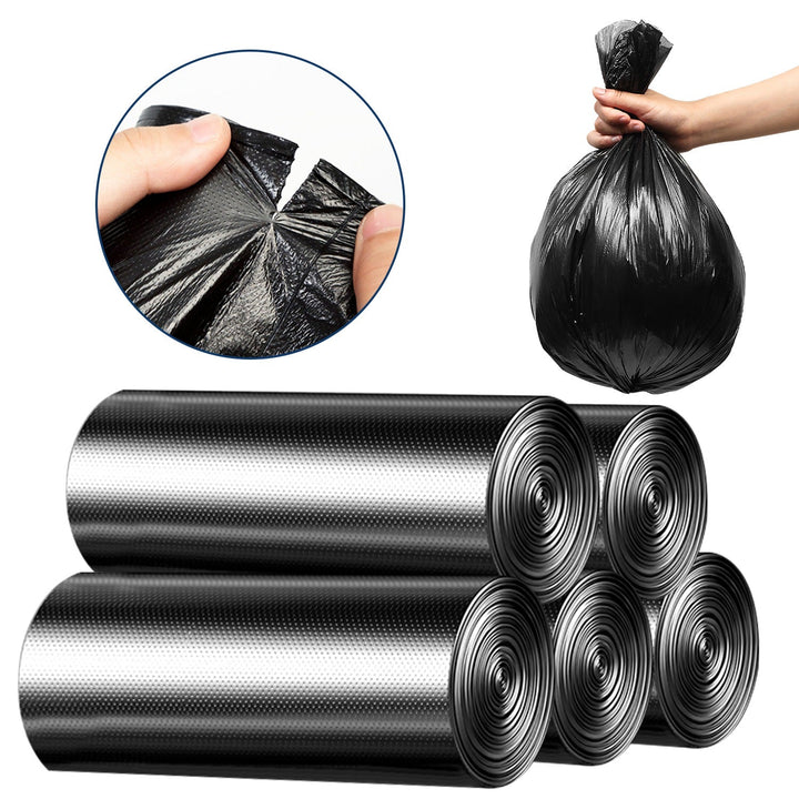 Black garbage bag rolls with crinkled plastic texture, hand holding liner