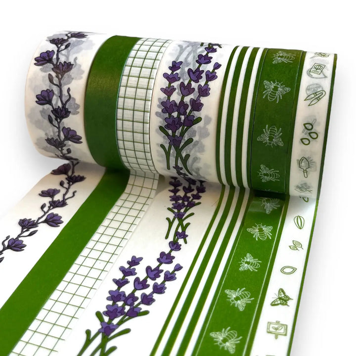 Unrolled washi tape showing green stripes, grid lines, and purple flower details