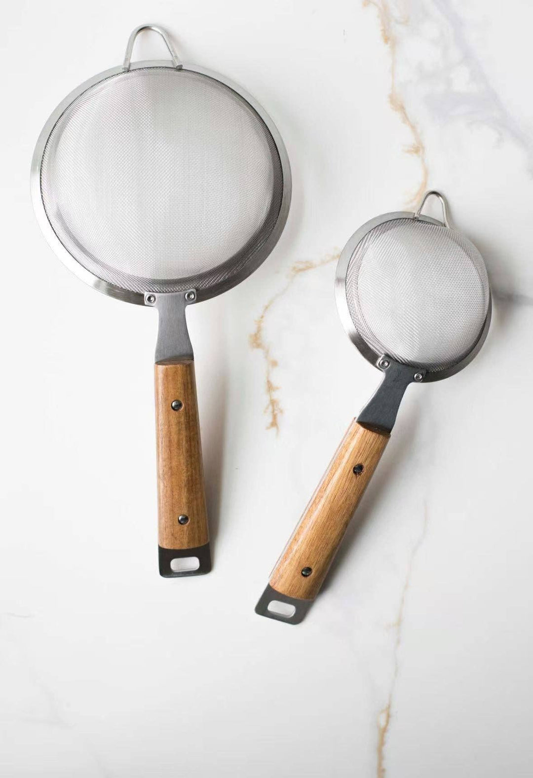 Pair of round mesh strainers: large and small with silver rims and wood handles