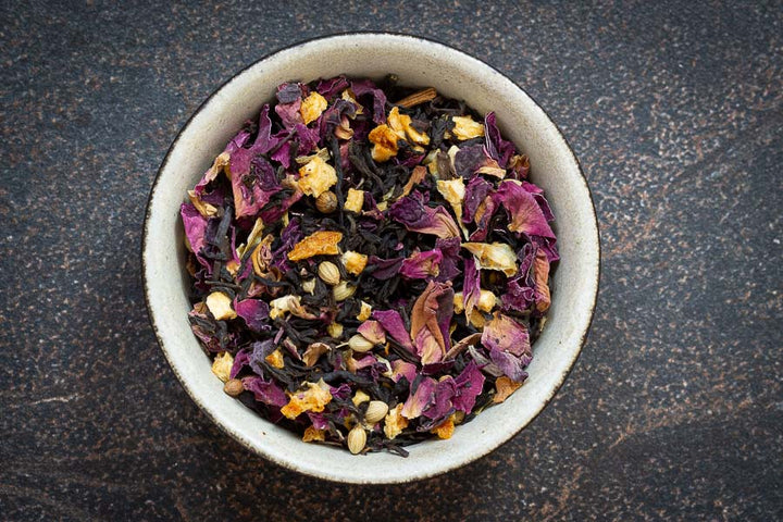 Tea tasting flight mixed loose-leaf tea with purple petals and golden flakes