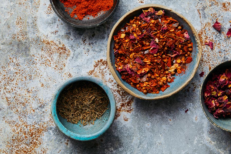 Rose Harissa spice blend in ceramic bowls with dried ground spice
